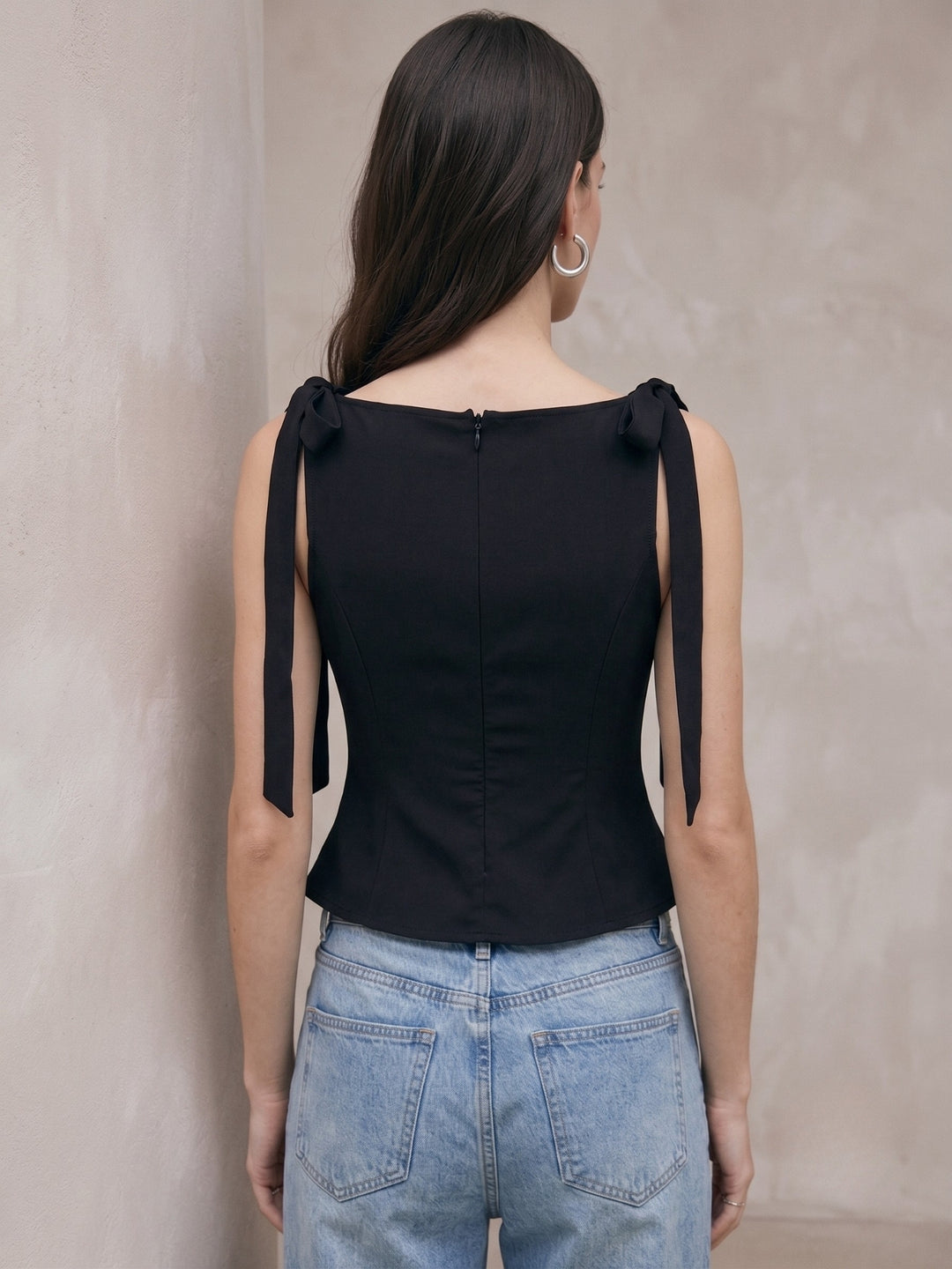 Black Peplum Top With Boat Neck And Bow Details On The Strap